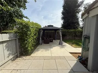 a patio with water view of the house