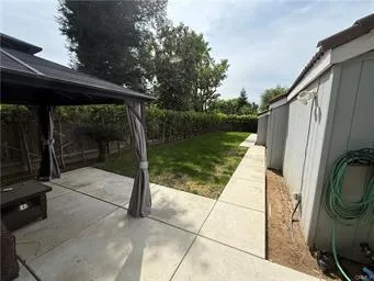 a view of house with backyard outdoor seating and barbeque oven