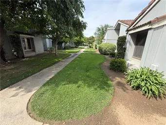 a view of a house with backyard and sitting area