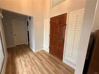 an empty room with wooden floor and a window