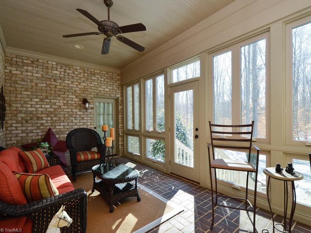 8301 Linville Oaks Drive Oak Ridge, NC 27310 - Photo 20 of 29 Sunroom/closed in porch opens to den, master suite and outdoors. (not heated and cooled)