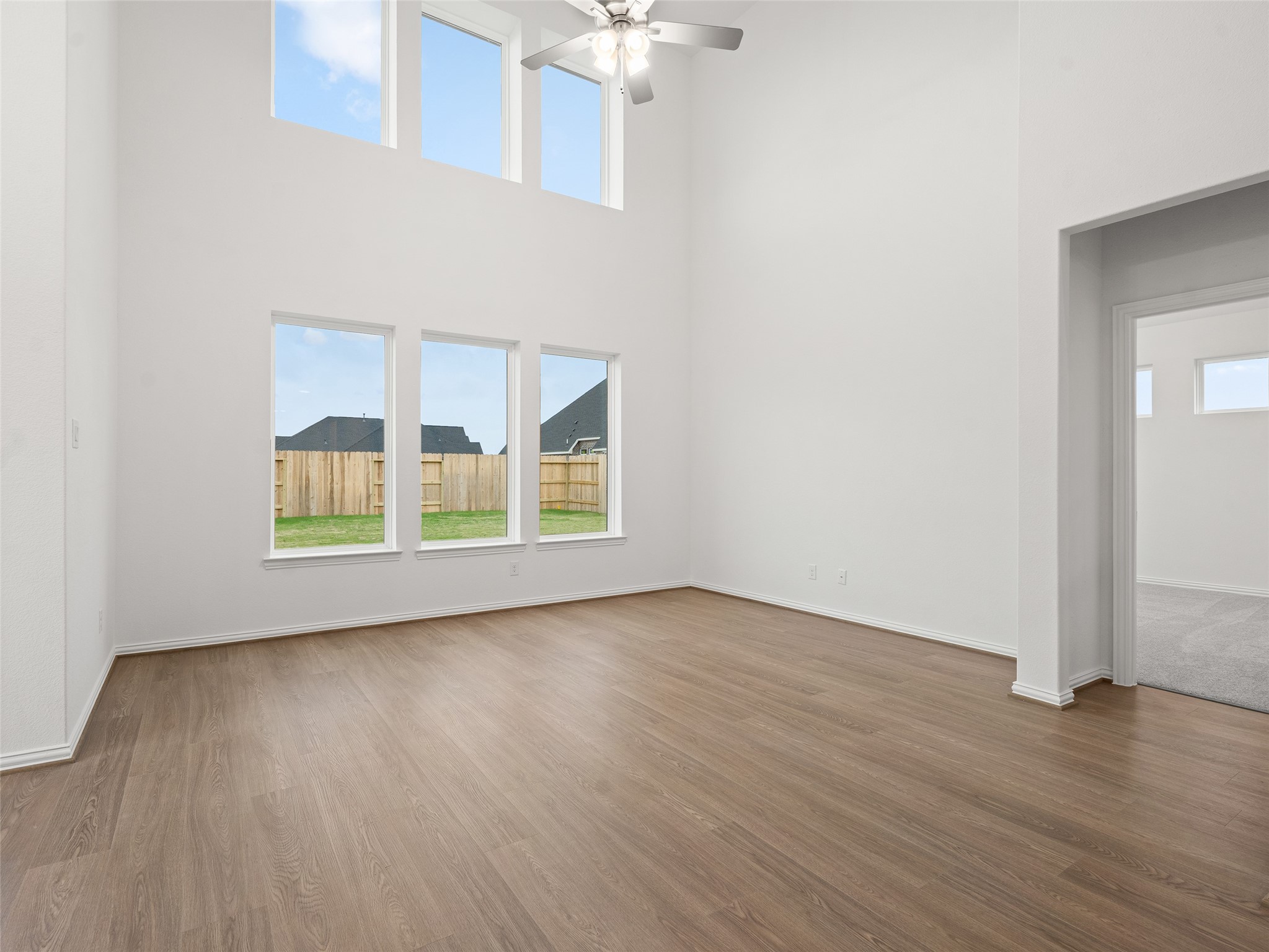 410 Strm Bnd Way Rosenberg, TX 77471 - Photo 15 of 39 a view of an empty room with wooden floor and a window