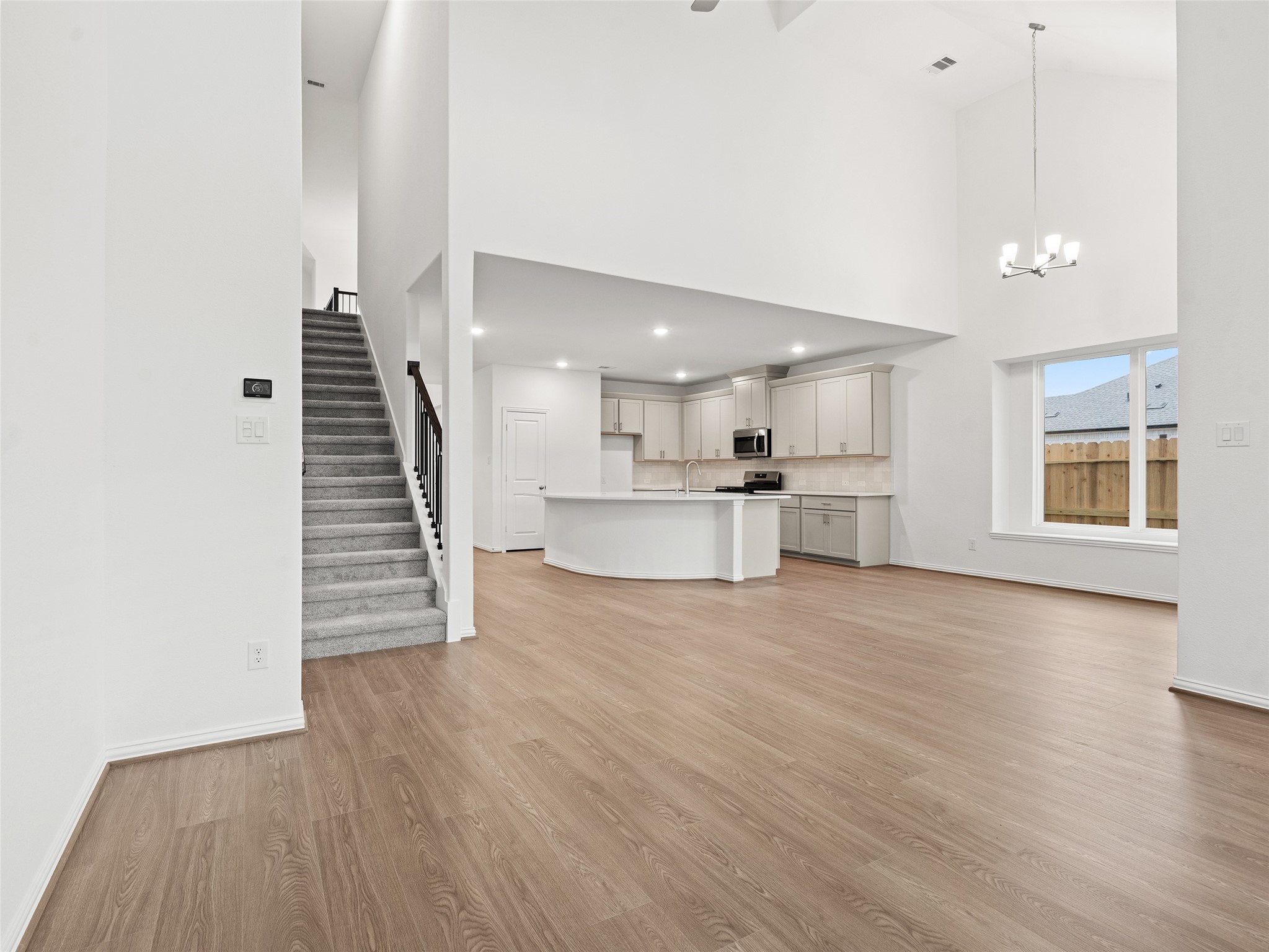 410 Strm Bnd Way Rosenberg, TX 77471 - Photo 16 of 39 an empty room with wooden floor and windows