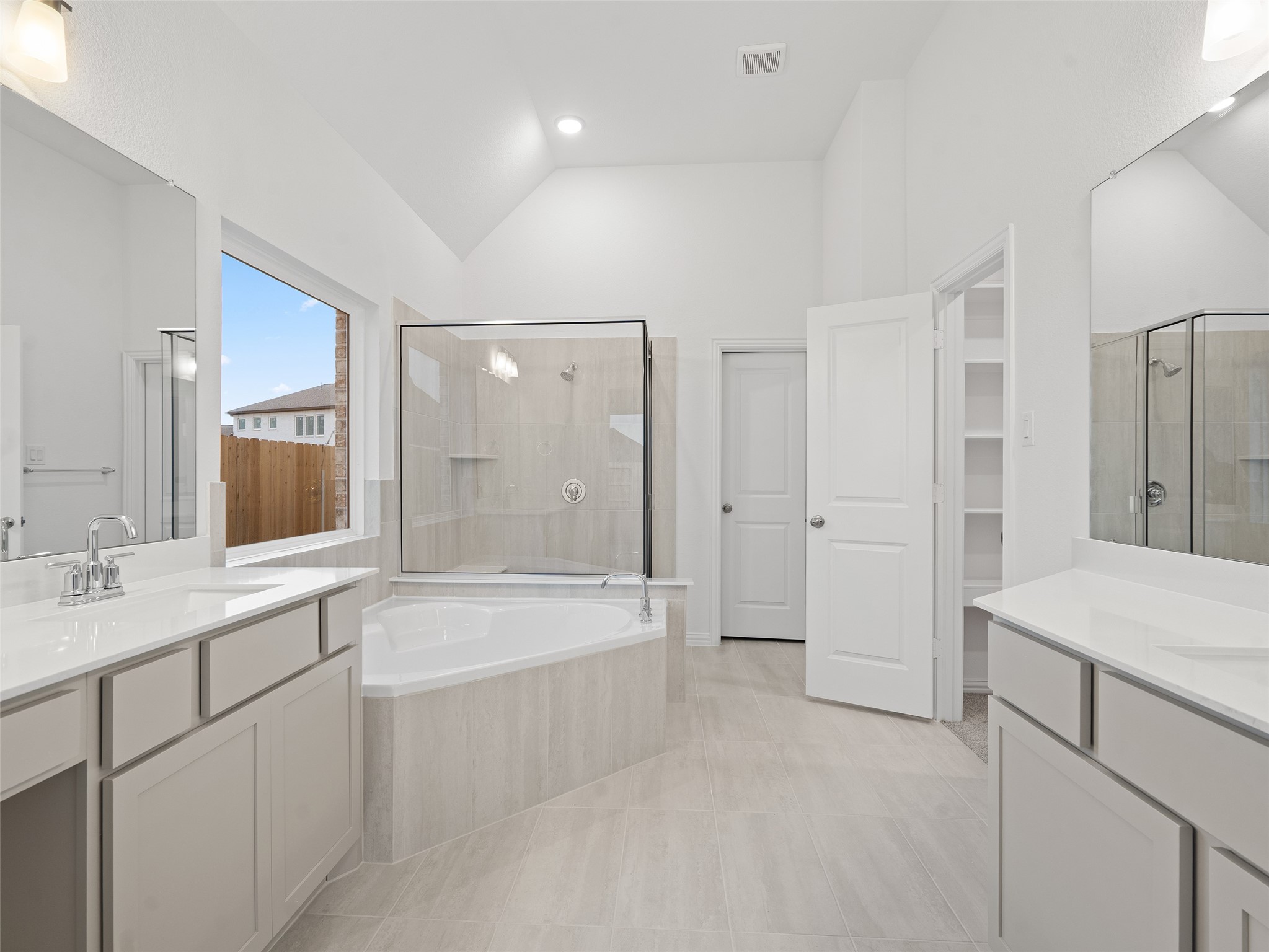 410 Strm Bnd Way Rosenberg, TX 77471 - Photo 20 of 39 a spacious bathroom with a shower tub double sink and mirror