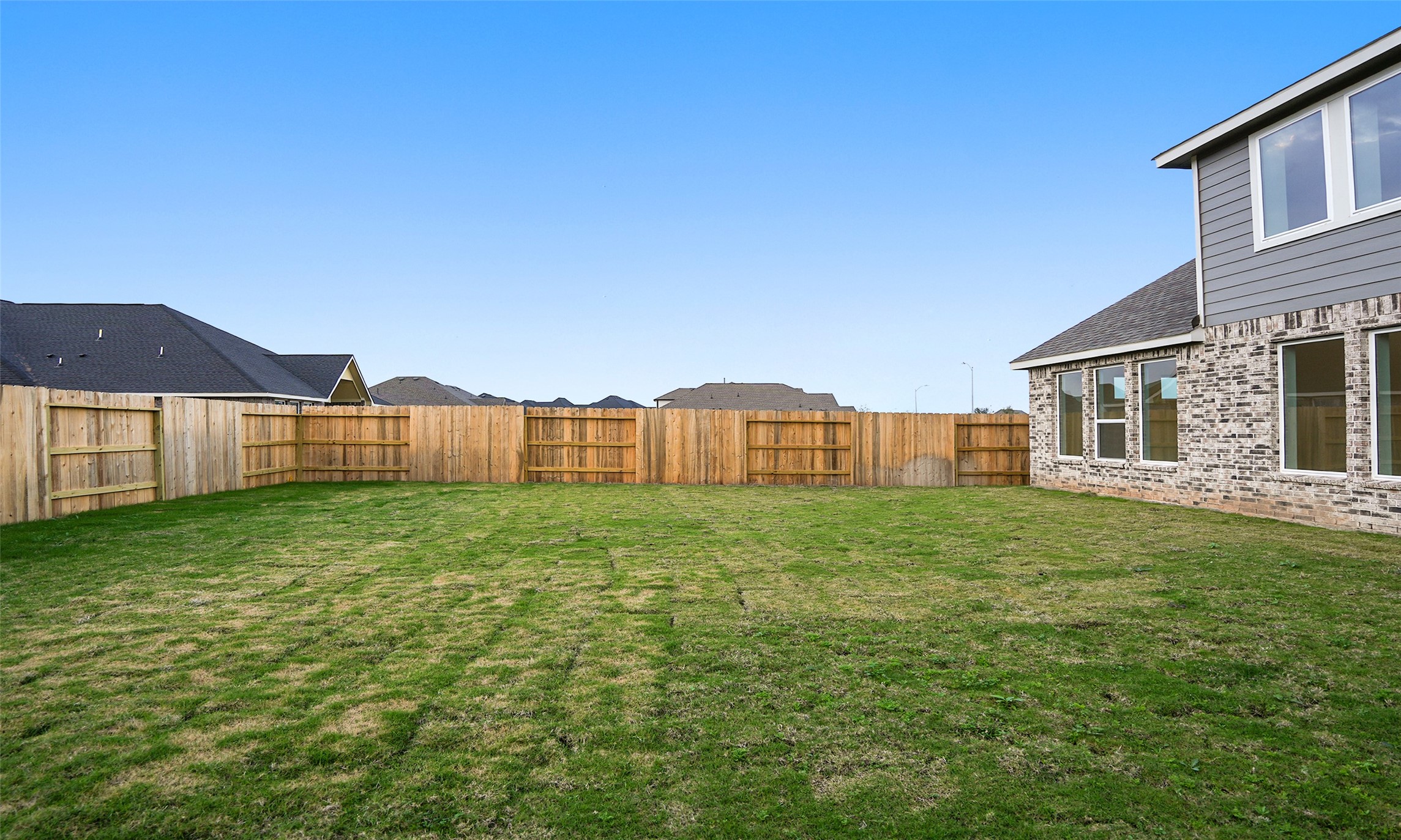 410 Strm Bnd Way Rosenberg, TX 77471 - Photo 36 of 39 a view of a backyard with table and chairs and wooden fence