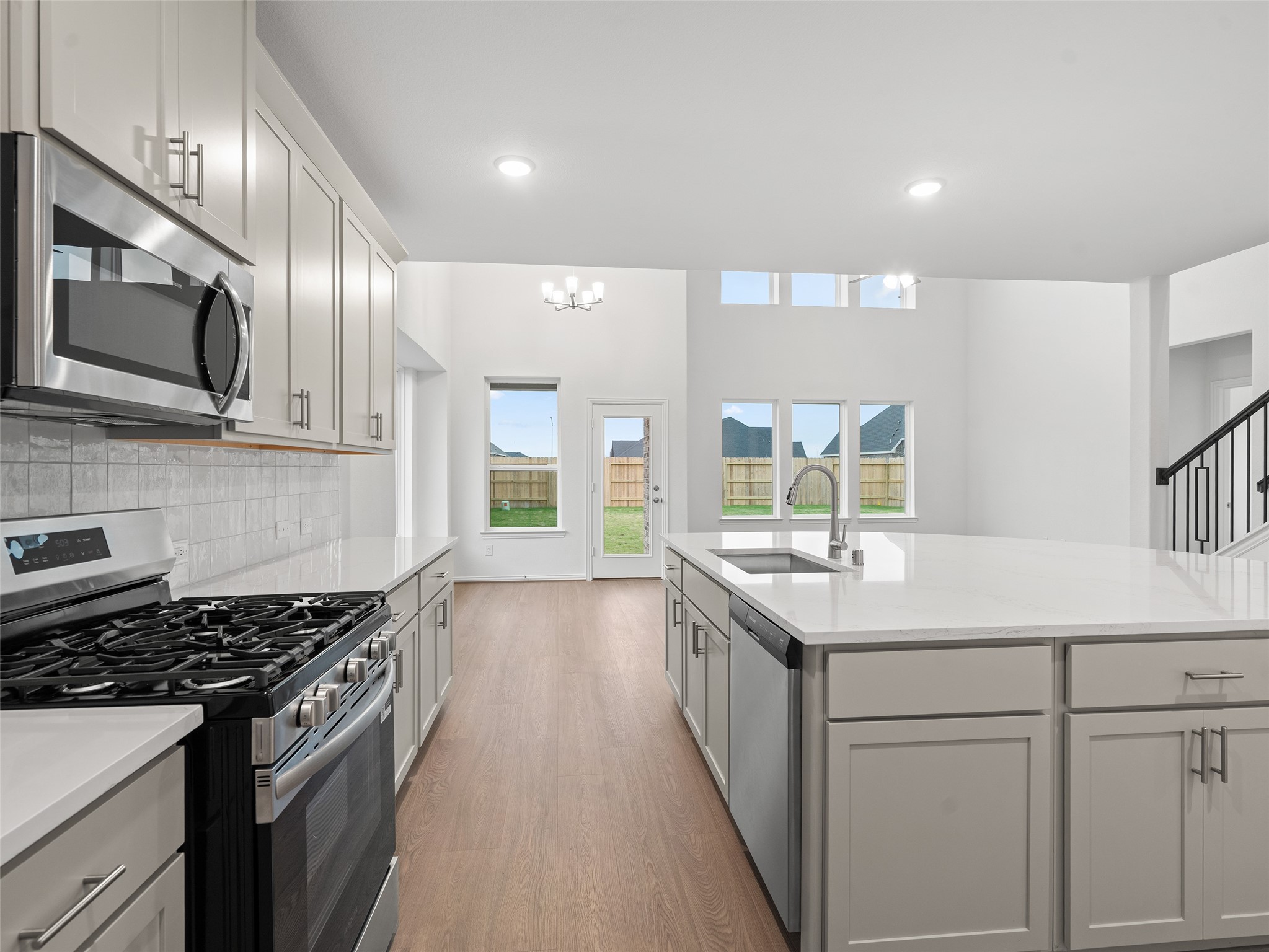 410 Strm Bnd Way Rosenberg, TX 77471 - Photo 10 of 39 a kitchen with stainless steel appliances a sink stove and cabinets