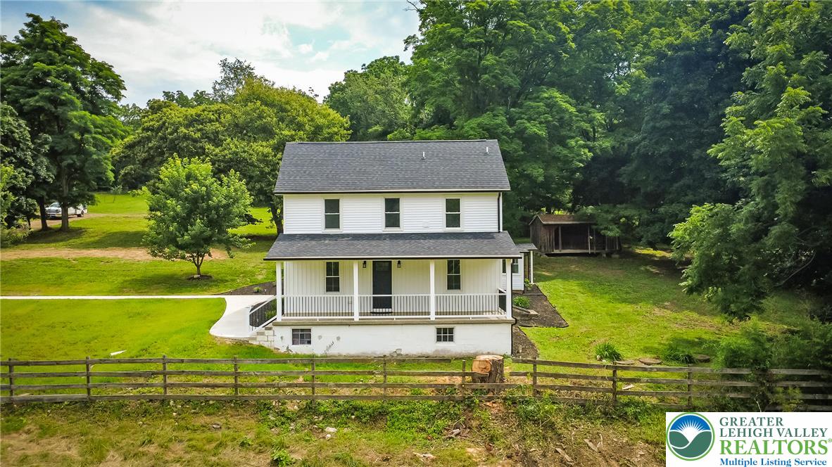 72 Allegheny Road Mount Bethel, PA 18343 - Photo 55 of 72 A classic farmhouse design, set on a verdant lot with a welcoming front porch and rustic fencing.