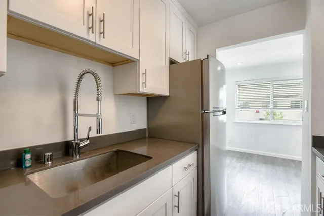 a kitchen with a sink and a refrigerator