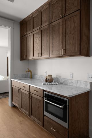 a view of a hallway with wooden floor and closet
