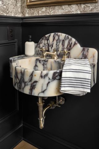 a bathroom with a granite countertop double vanity sinks and mirror