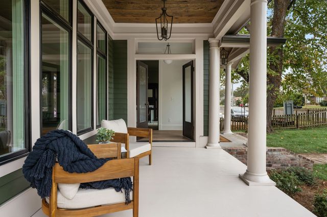 a living room filled with furniture and a chandelier