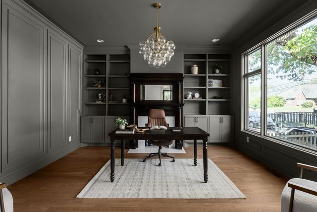 a dining room with furniture potted plants and wooden floor