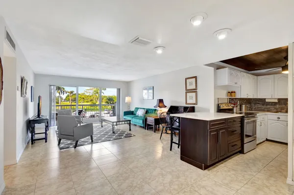 a view of a kitchen with kitchen island and a wooden floors