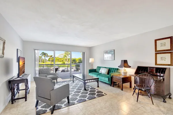 a living room with furniture a window and a flat screen tv