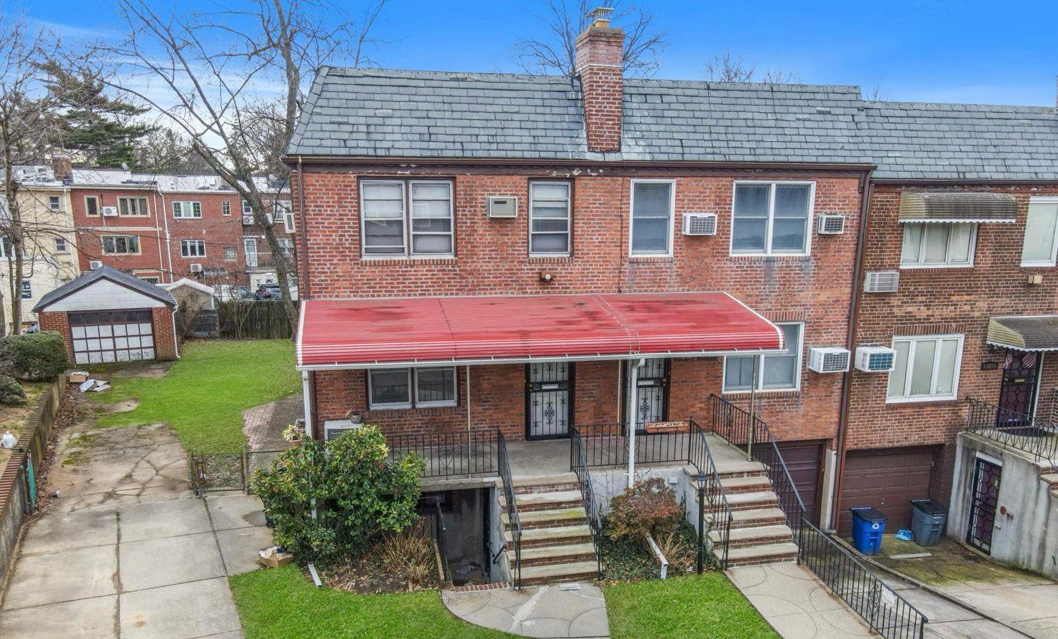 138-12 76th Avenue Queens, NY 11367 - Photo 2 of 12 View of front of home featuring brick siding, a garage, a chimney, a high end roof, and concrete driveway