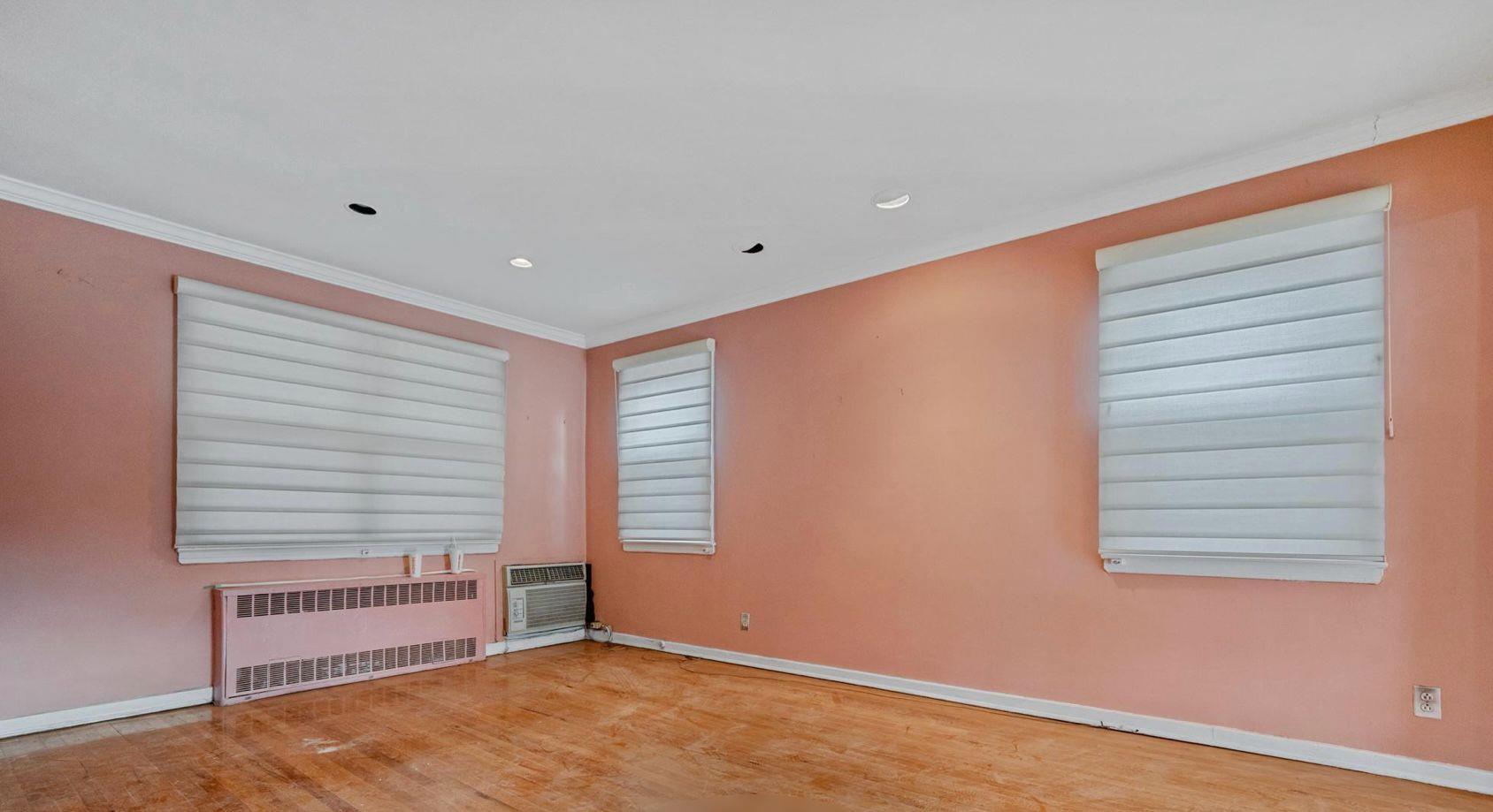 138-12 76th Avenue Queens, NY 11367 - Photo 4 of 12 Unfurnished room featuring radiator heating unit, baseboards, wood finished floors, recessed lighting, and ornamental molding