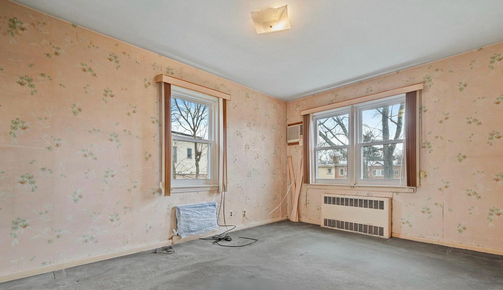 138-12 76th Avenue Queens, NY 11367 - Photo 6 of 12 Spare room featuring radiator heating unit, healthy amount of natural light, carpet floors, and wallpapered walls