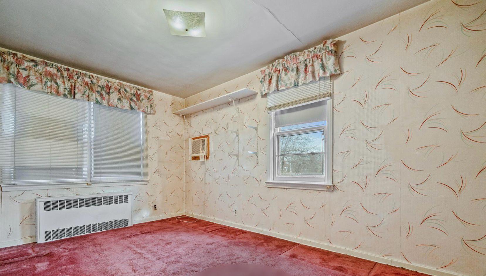 138-12 76th Avenue Queens, NY 11367 - Photo 7 of 12 Carpeted empty room with radiator