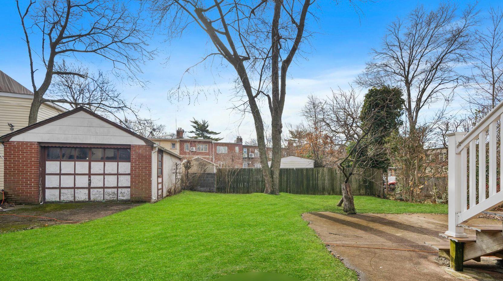 138-12 76th Avenue Queens, NY 11367 - Photo 10 of 12 View of yard featuring an outdoor structure and a detached garage
