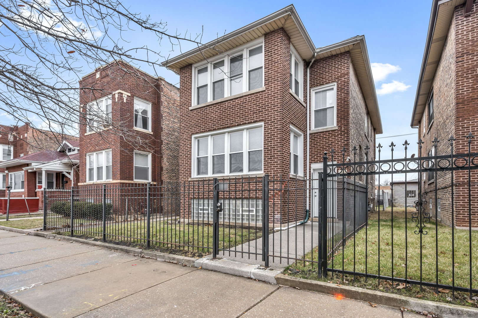 7924 South May Street, Unit 2 Chicago, IL 60620 - Photo 1 of 10 a view of a brick building next to a yard
