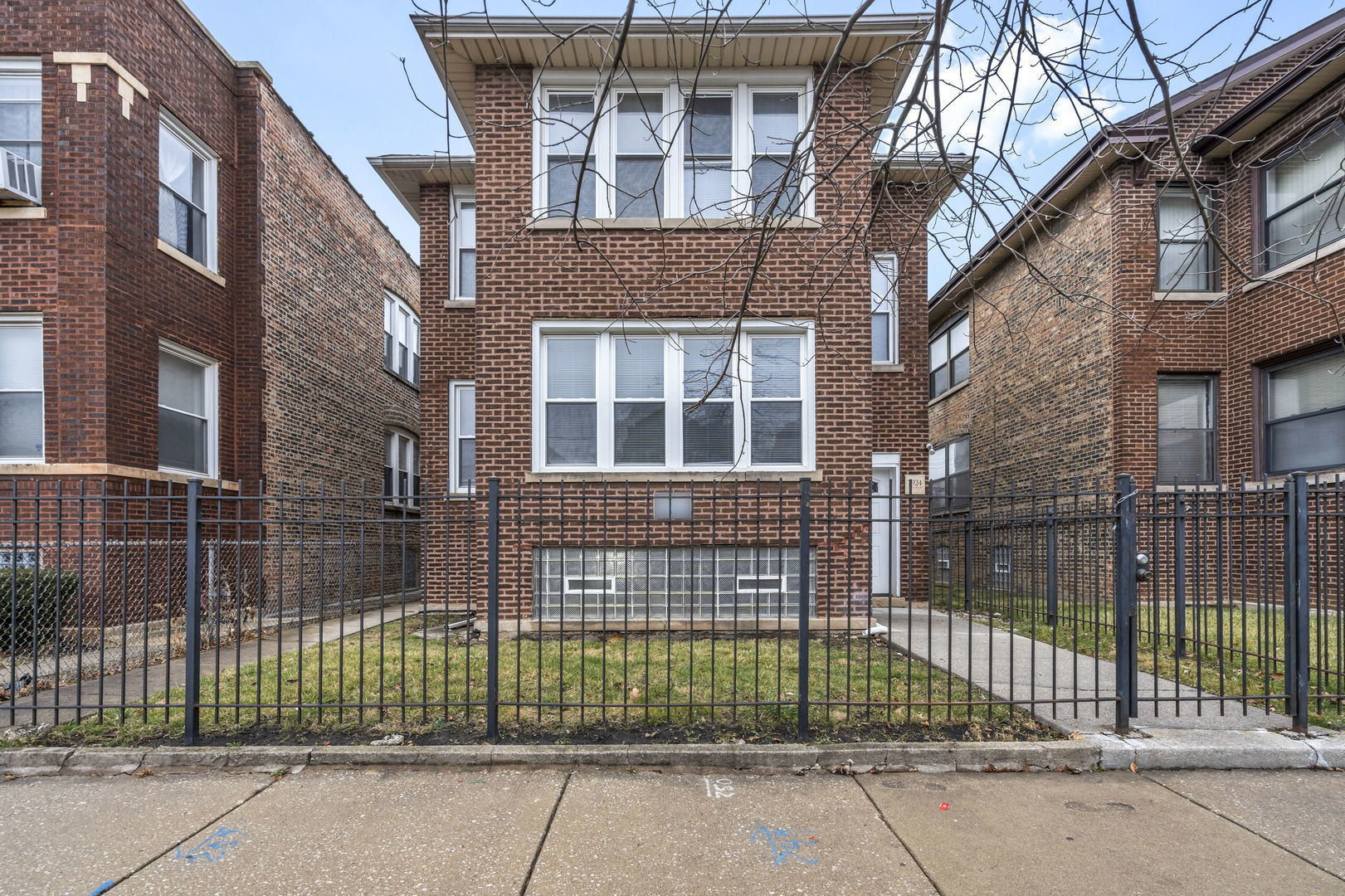 7924 South May Street, Unit 2 Chicago, IL 60620 - Photo 2 of 10 a view of brick building with a small yard