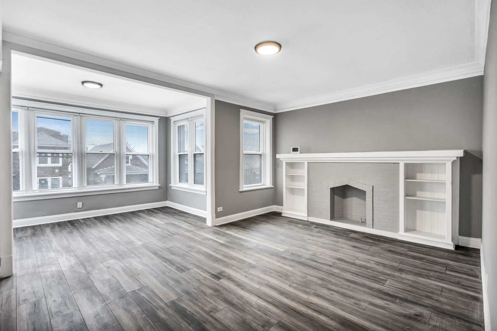 7924 South May Street, Unit 2 Chicago, IL 60620 - Photo 3 of 10 a view of an empty room with wooden floor and a window