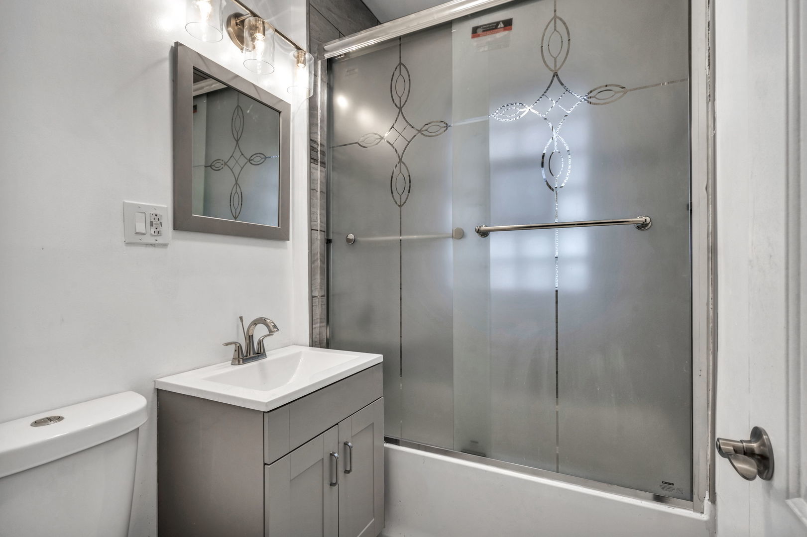 7924 South May Street, Unit 2 Chicago, IL 60620 - Photo 6 of 10 a bathroom with a shower sink vanity and toilet