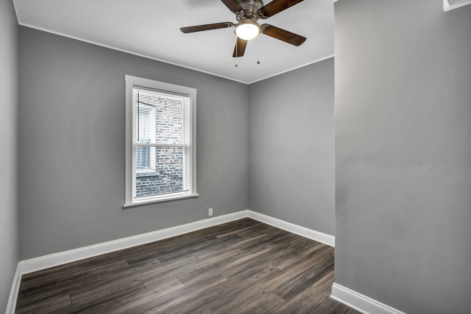 7924 South May Street, Unit 2 Chicago, IL 60620 - Photo 7 of 10 a view of an empty room with wooden floor and a window