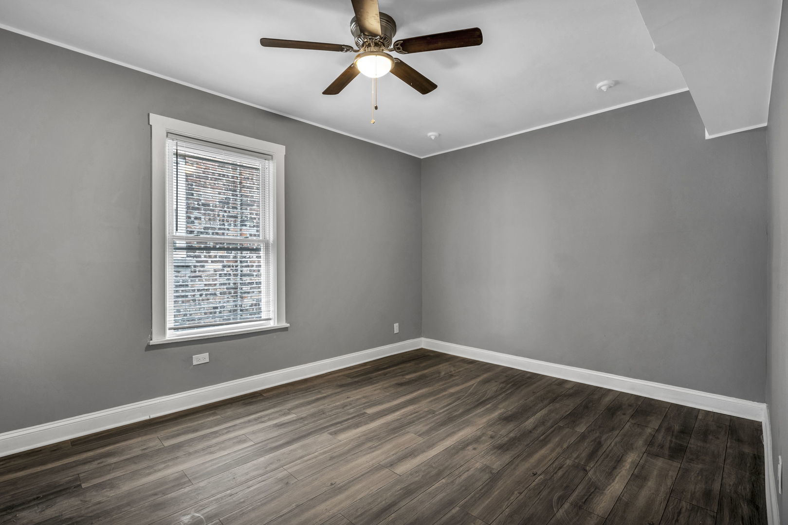 7924 South May Street, Unit 2 Chicago, IL 60620 - Photo 8 of 10 a view of a room with wooden floor and a ceiling fan