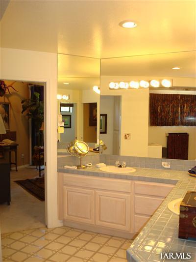 9985 North Desert Sky Road Oro Valley, AZ 85737 - Photo 22 of 43 a bathroom with a sink vanity and a mirror