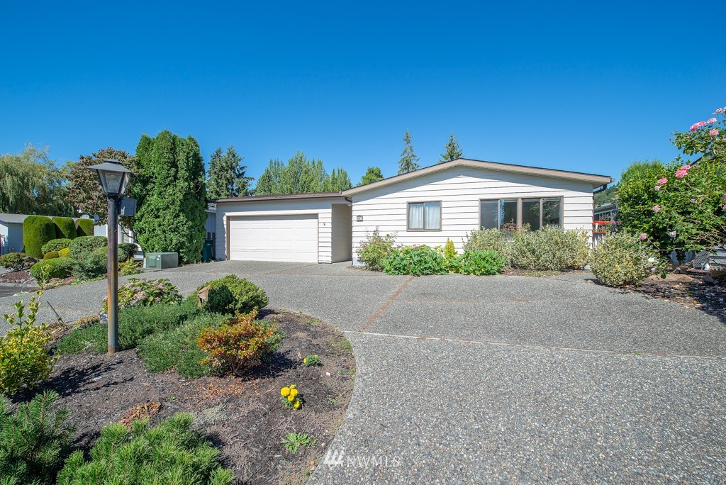 907 240th Place Southwest Bothell, WA 98021 - Photo 1 of 24 a front view of a house with a garden