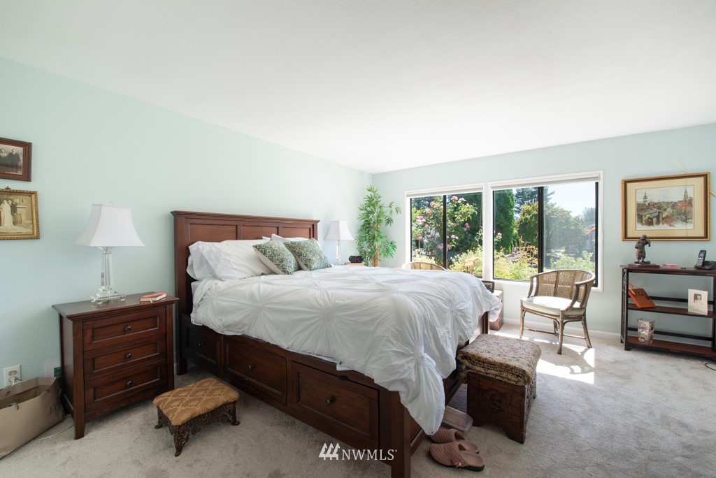 907 240th Place Southwest Bothell, WA 98021 - Photo 12 of 24 a bedroom with a bed and a couch next to a window