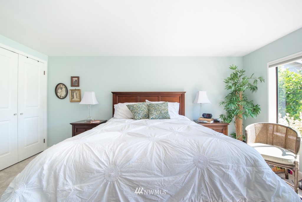 907 240th Place Southwest Bothell, WA 98021 - Photo 13 of 24 a bedroom with a bed and a chair