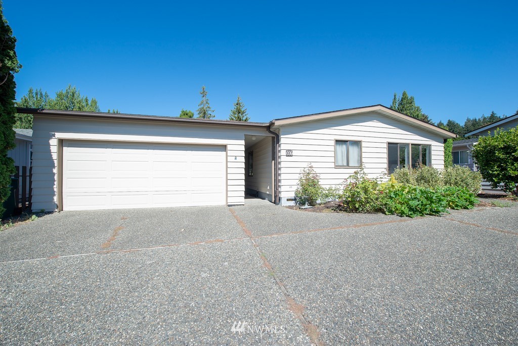 907 240th Place Southwest Bothell, WA 98021 - Photo 24 of 24 a front view of a house with a yard and garage