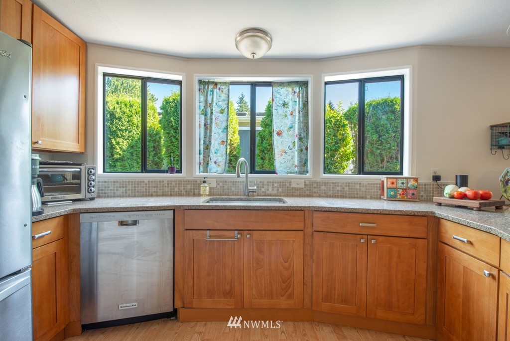 907 240th Place Southwest Bothell, WA 98021 - Photo 5 of 24 a kitchen with a sink window and cabinets