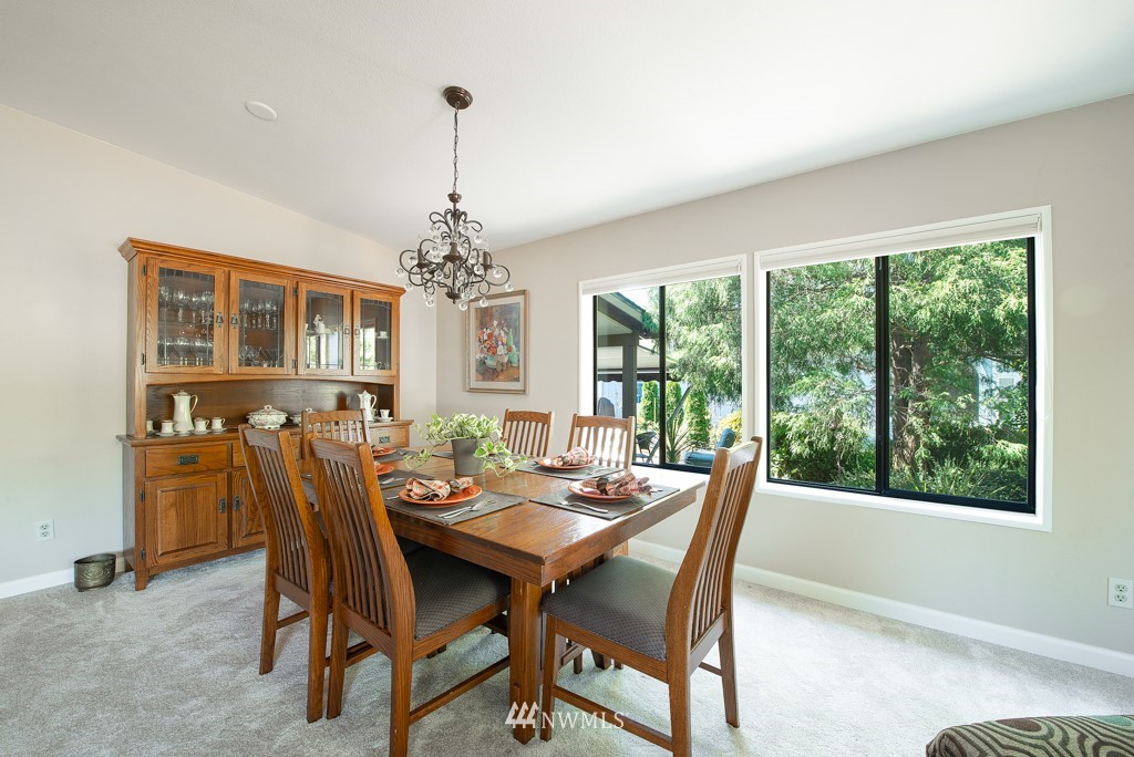 907 240th Place Southwest Bothell, WA 98021 - Photo 9 of 24 a dining room with furniture a chandelier and window