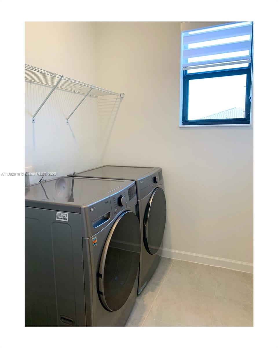 11909 Southwest 244th Street, Unit 11909 Homestead, FL 33032 - Photo 18 of 45 a utility room with dryer and washer