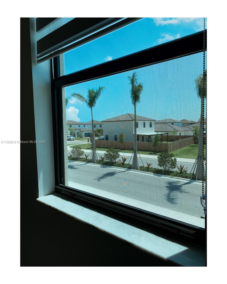 11909 Southwest 244th Street, Unit 11909 Homestead, FL 33032 - Photo 23 of 45 a view of a back yard from a window