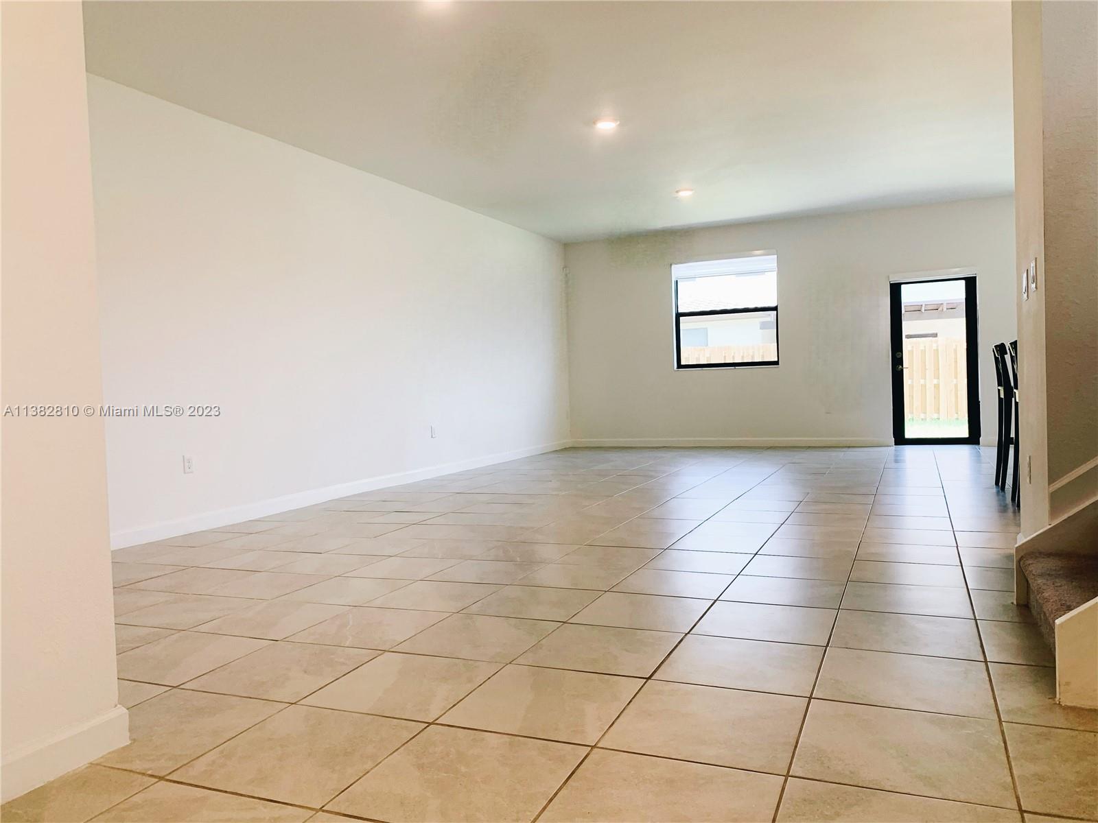 11909 Southwest 244th Street, Unit 11909 Homestead, FL 33032 - Photo 3 of 45 a view of an empty room and a window