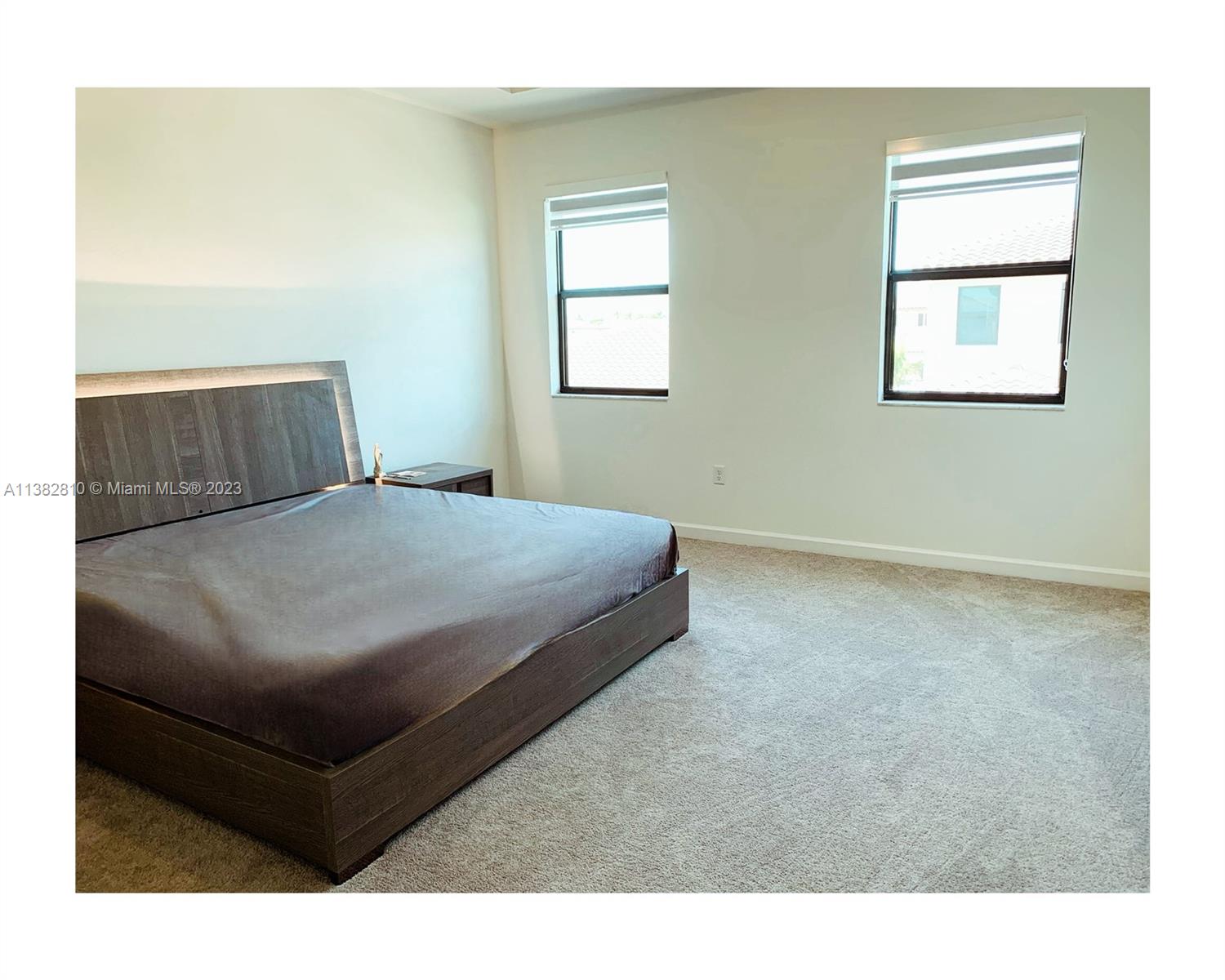 11909 Southwest 244th Street, Unit 11909 Homestead, FL 33032 - Photo 32 of 45 a bedroom with a bed and window