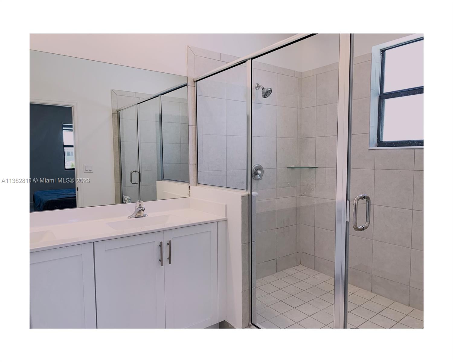 11909 Southwest 244th Street, Unit 11909 Homestead, FL 33032 - Photo 36 of 45 a bathroom with a shower sink and mirror