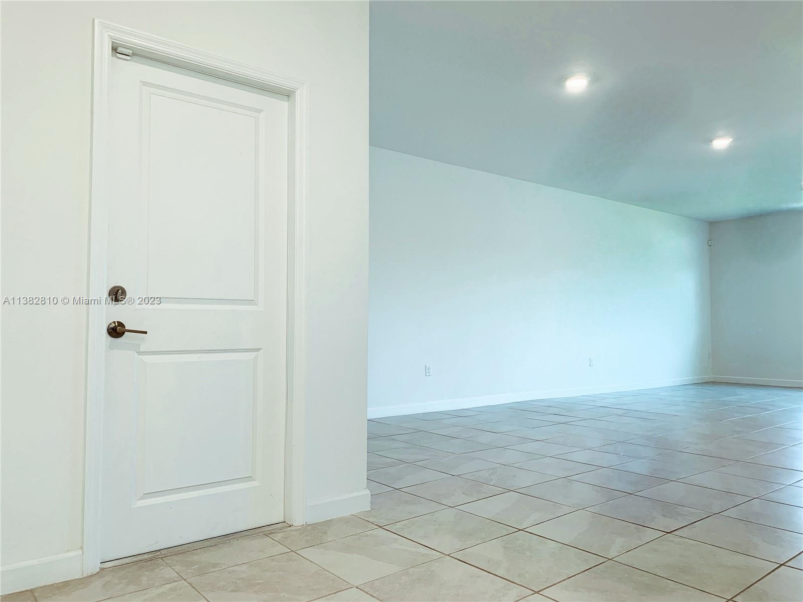 11909 Southwest 244th Street, Unit 11909 Homestead, FL 33032 - Photo 4 of 45 an empty room with white walls