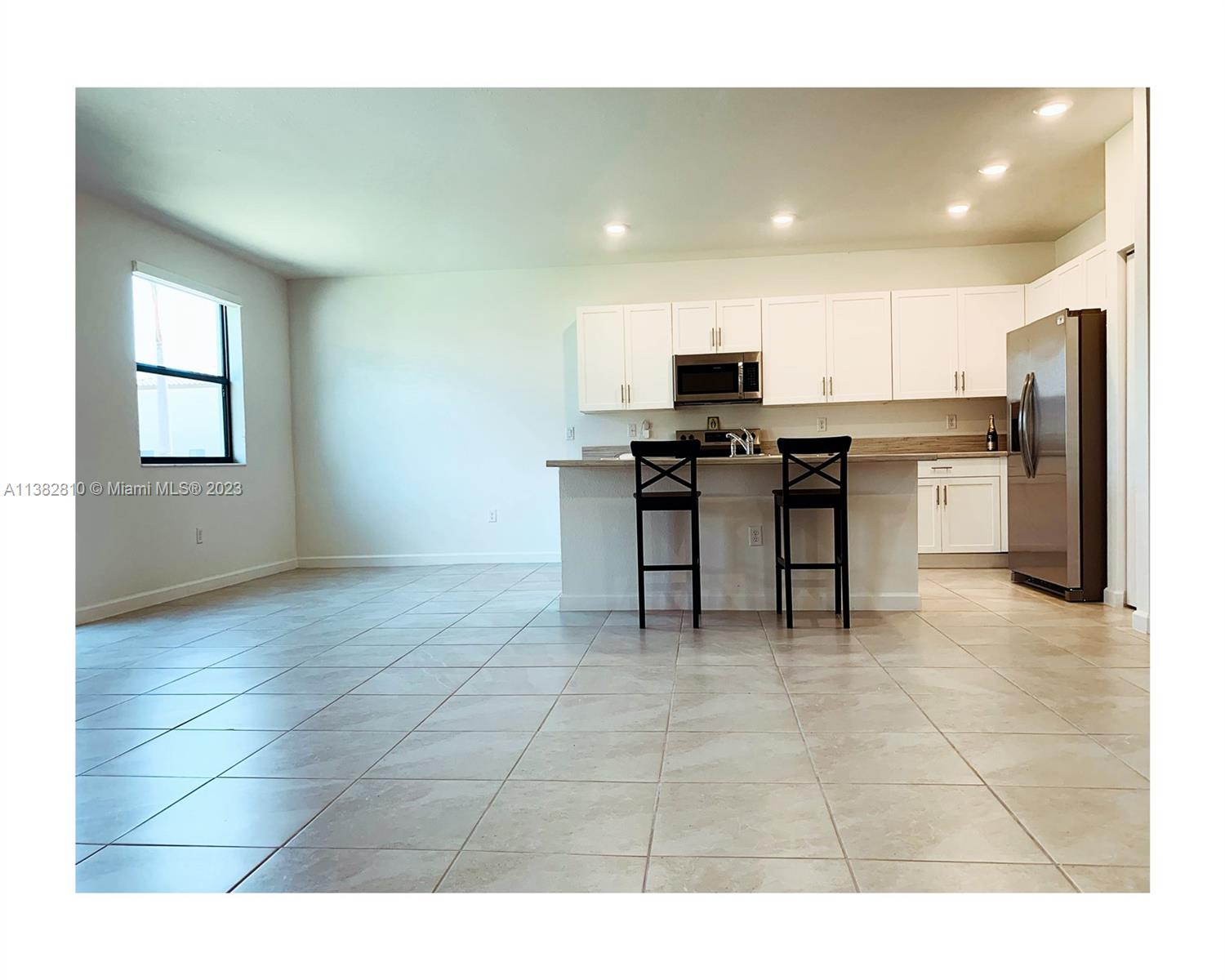 11909 Southwest 244th Street, Unit 11909 Homestead, FL 33032 - Photo 6 of 45 a view of kitchen with furniture and stainless steel appliances