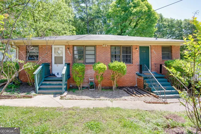 a front view of house with yard and outdoor seating