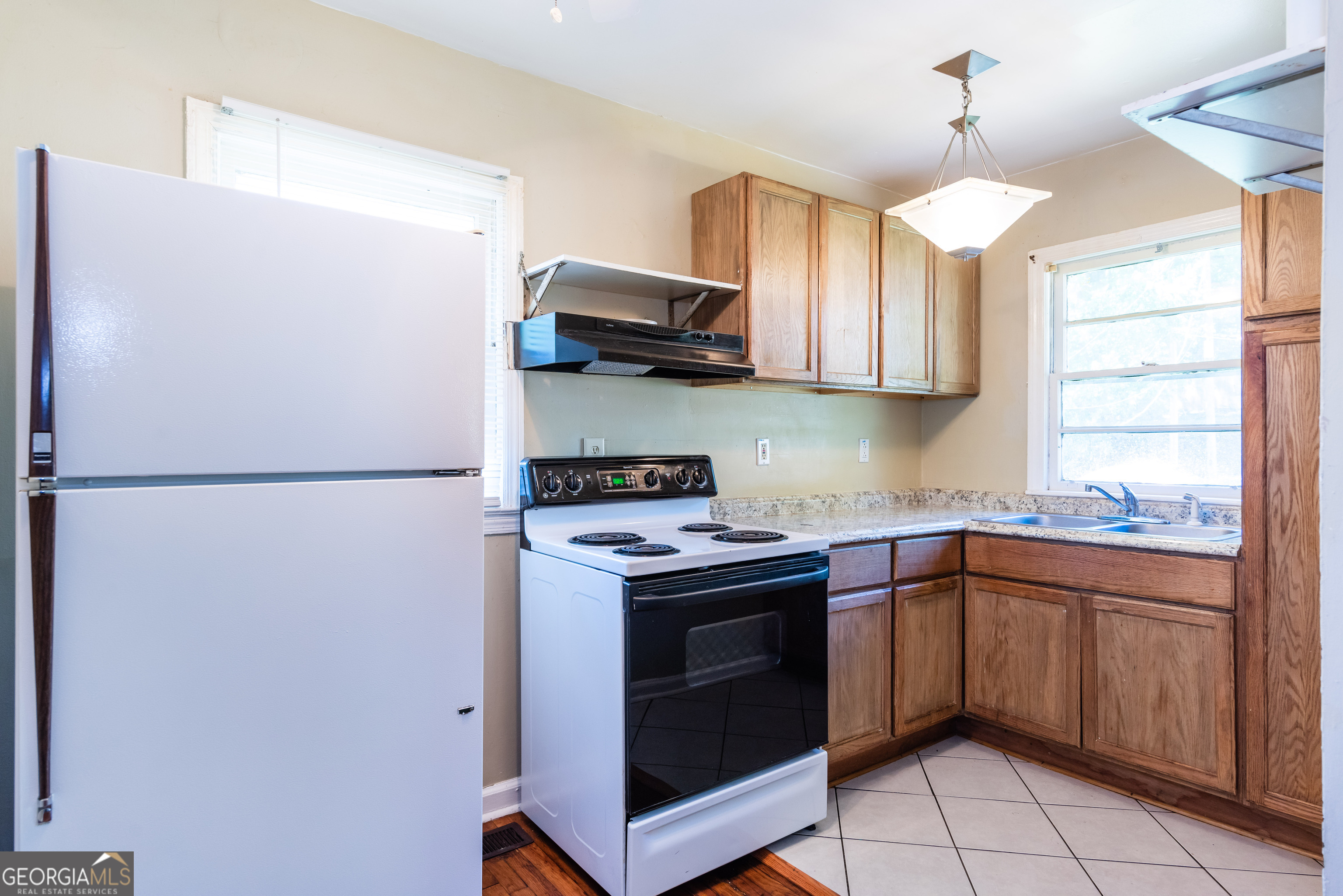 2982 Pearl Street Atlanta, GA 30344 - Photo 4 of 11 a kitchen with stainless steel appliances granite countertop a refrigerator a sink a stove and a refrigerator