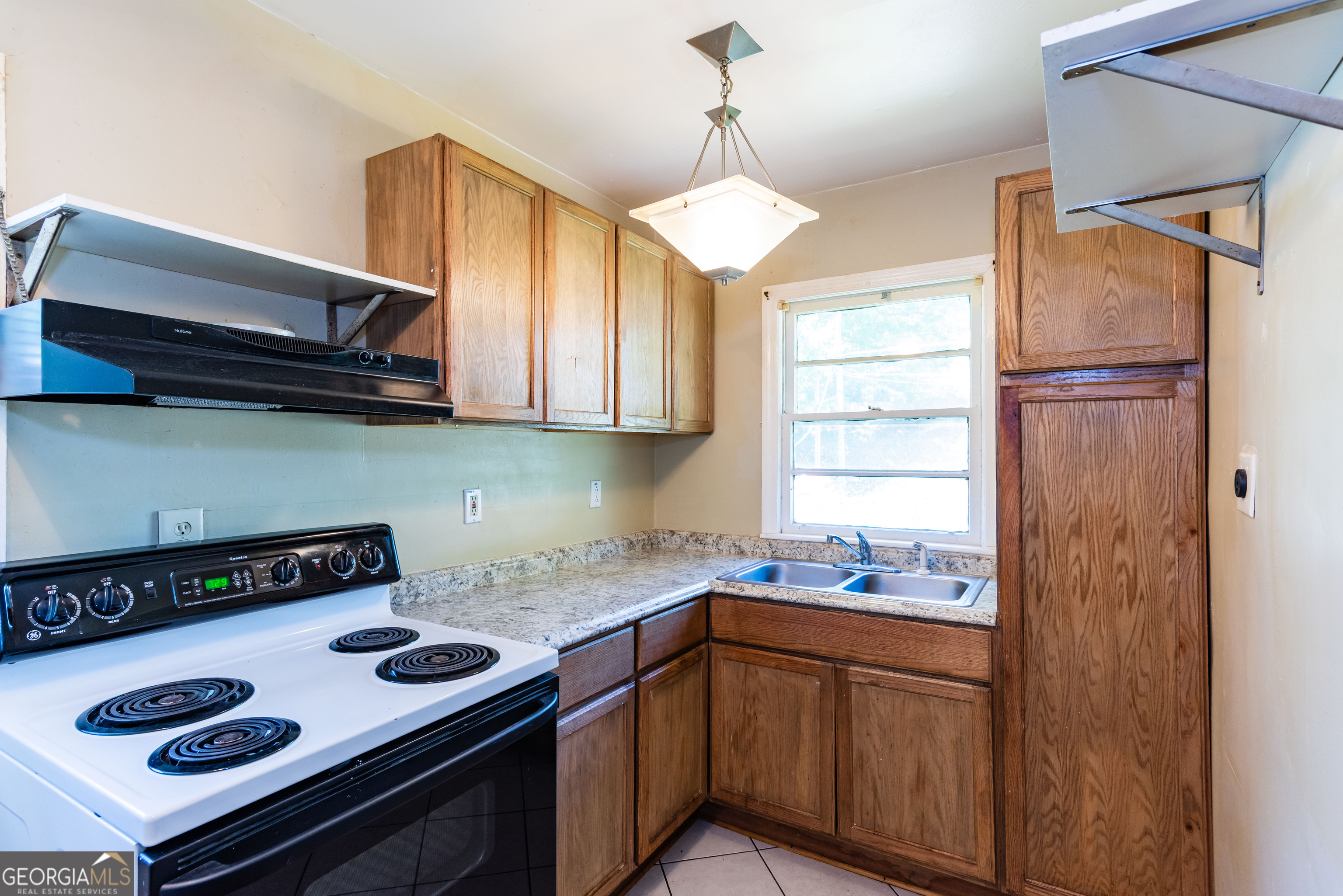 2982 Pearl Street Atlanta, GA 30344 - Photo 5 of 11 a kitchen with stainless steel appliances granite countertop a sink stove and cabinets