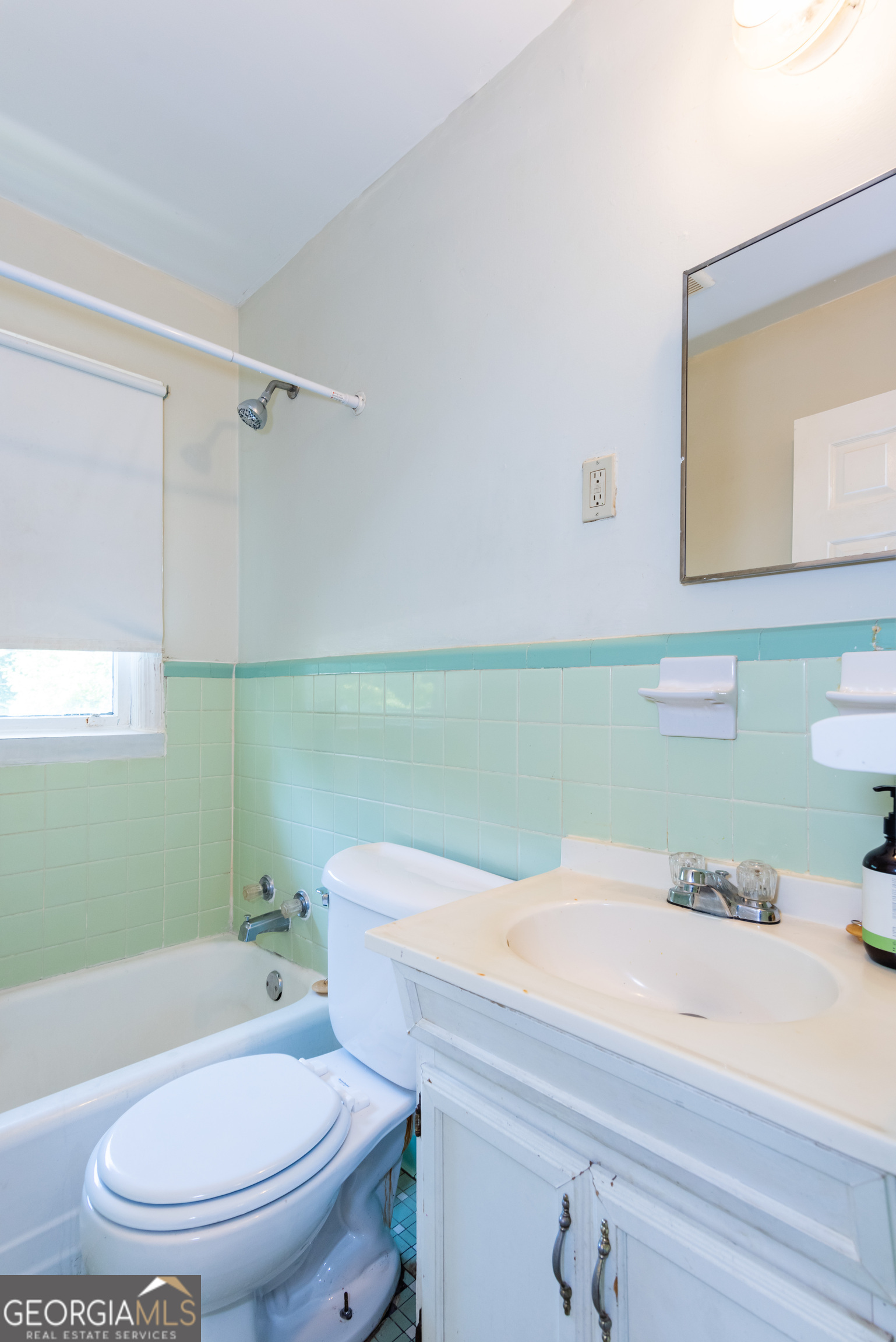 2982 Pearl Street Atlanta, GA 30344 - Photo 7 of 11 a bathroom with a sink a toilet and mirror