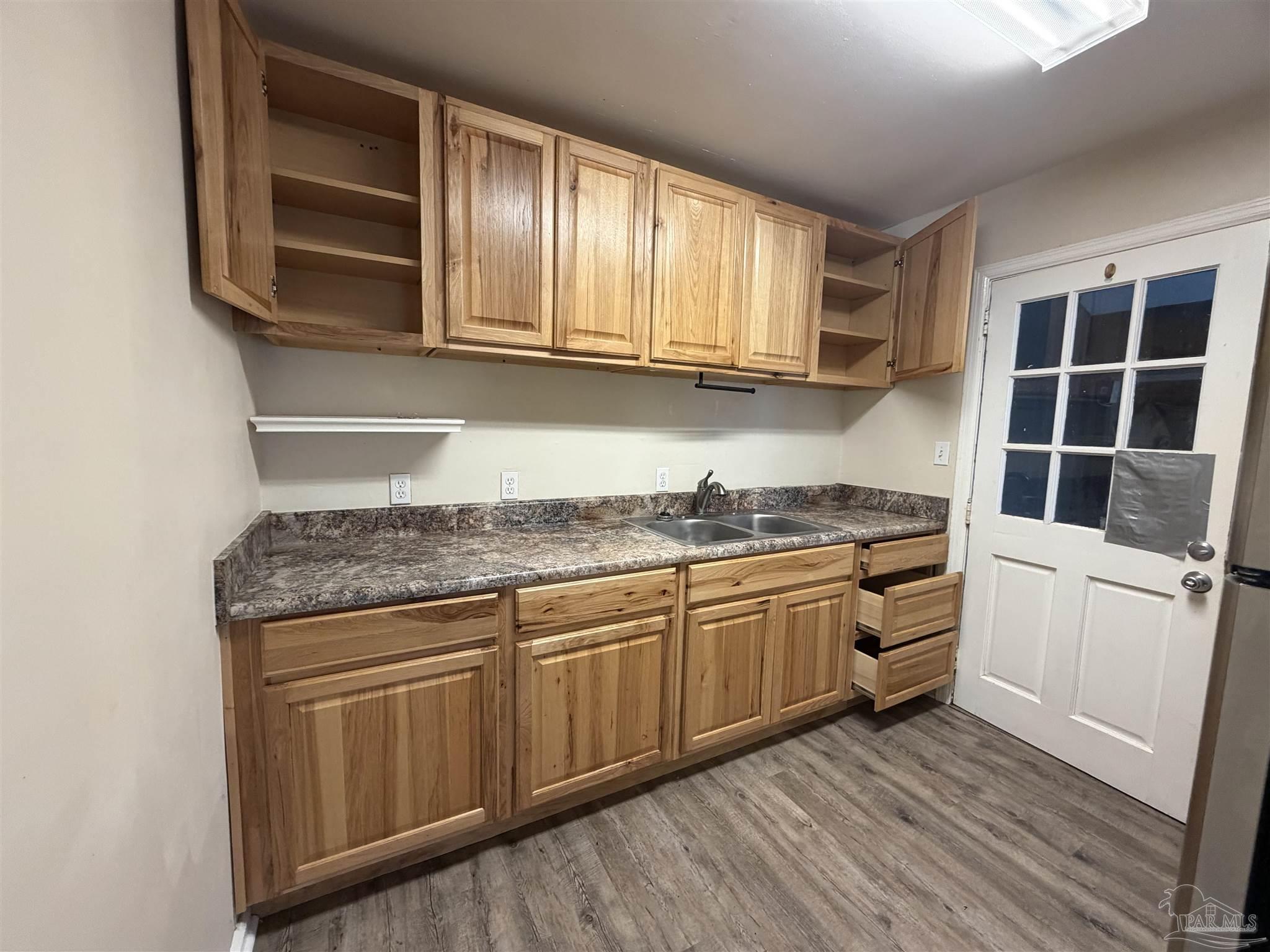 102 Morris Avenue Cantonment, FL 32533 - Photo 3 of 12 a kitchen with stainless steel appliances granite countertop a stove and a sink