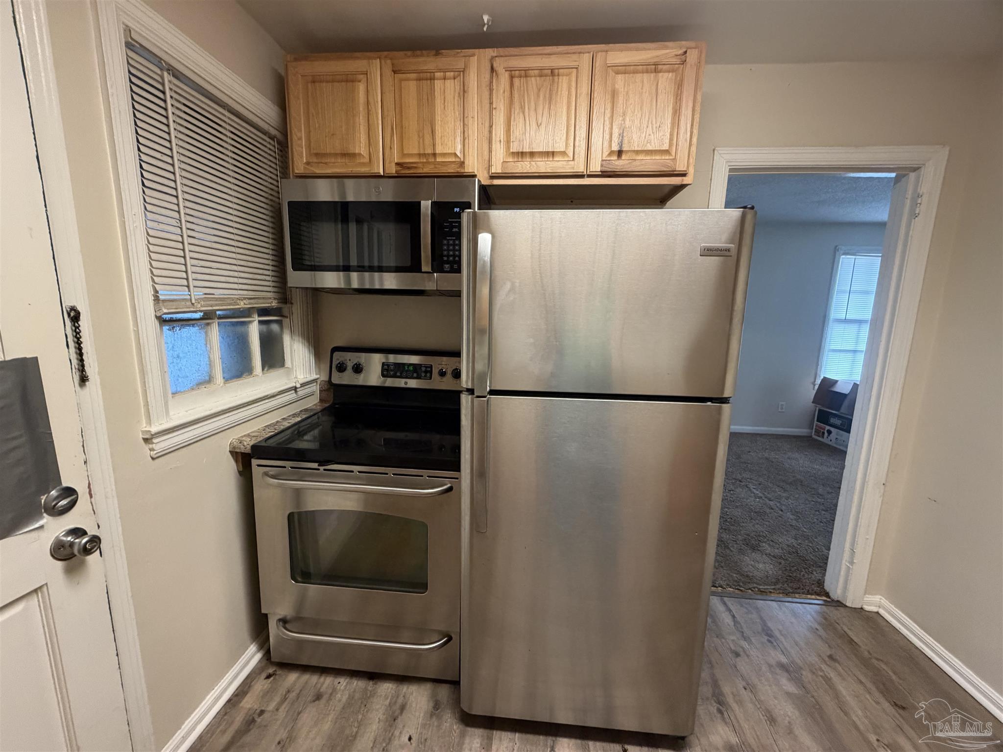 102 Morris Avenue Cantonment, FL 32533 - Photo 4 of 12 a kitchen with a refrigerator sink and cabinets