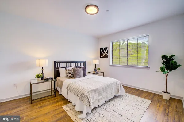 a bedroom with a bed and a potted plant